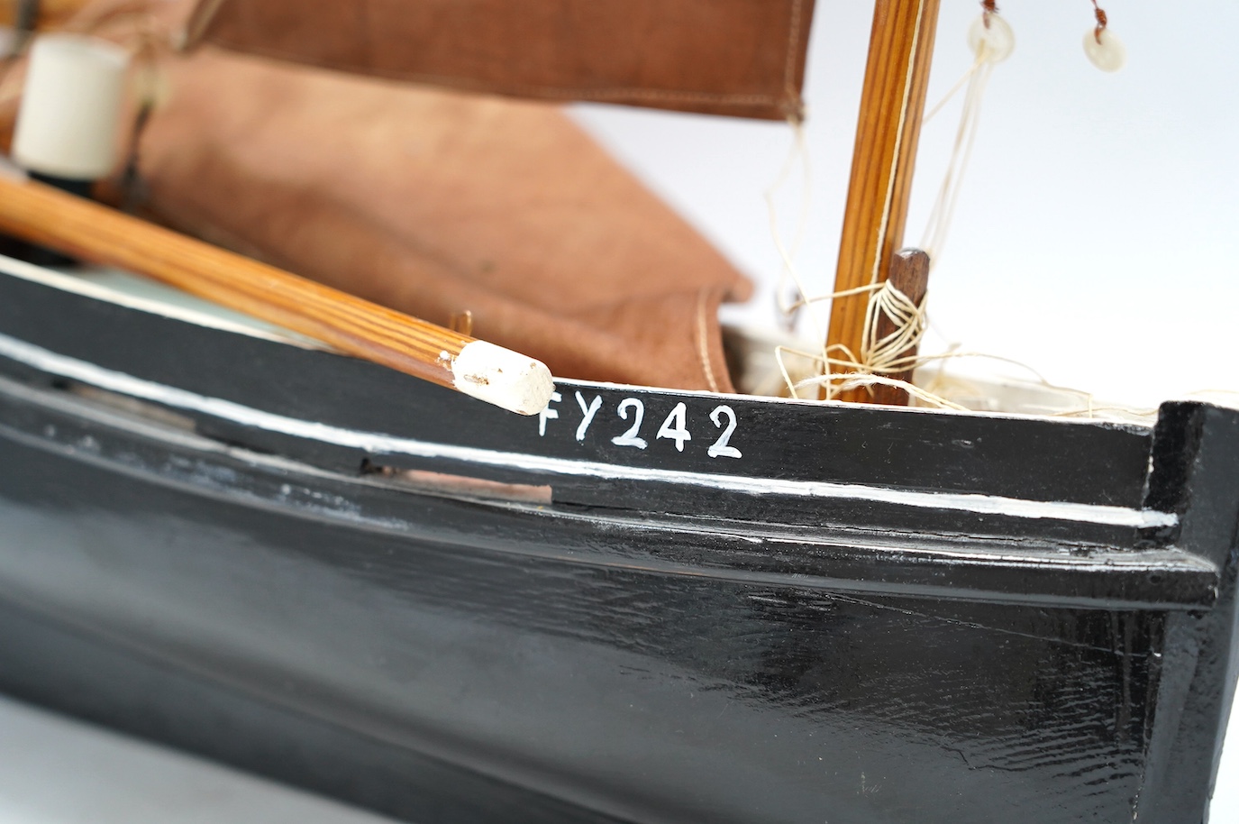 A painted wood pond yacht, 77cm in length. Condition - one mast broken